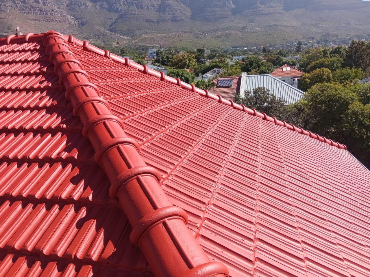 Freshly painted red roof tiles with mountain backdrop