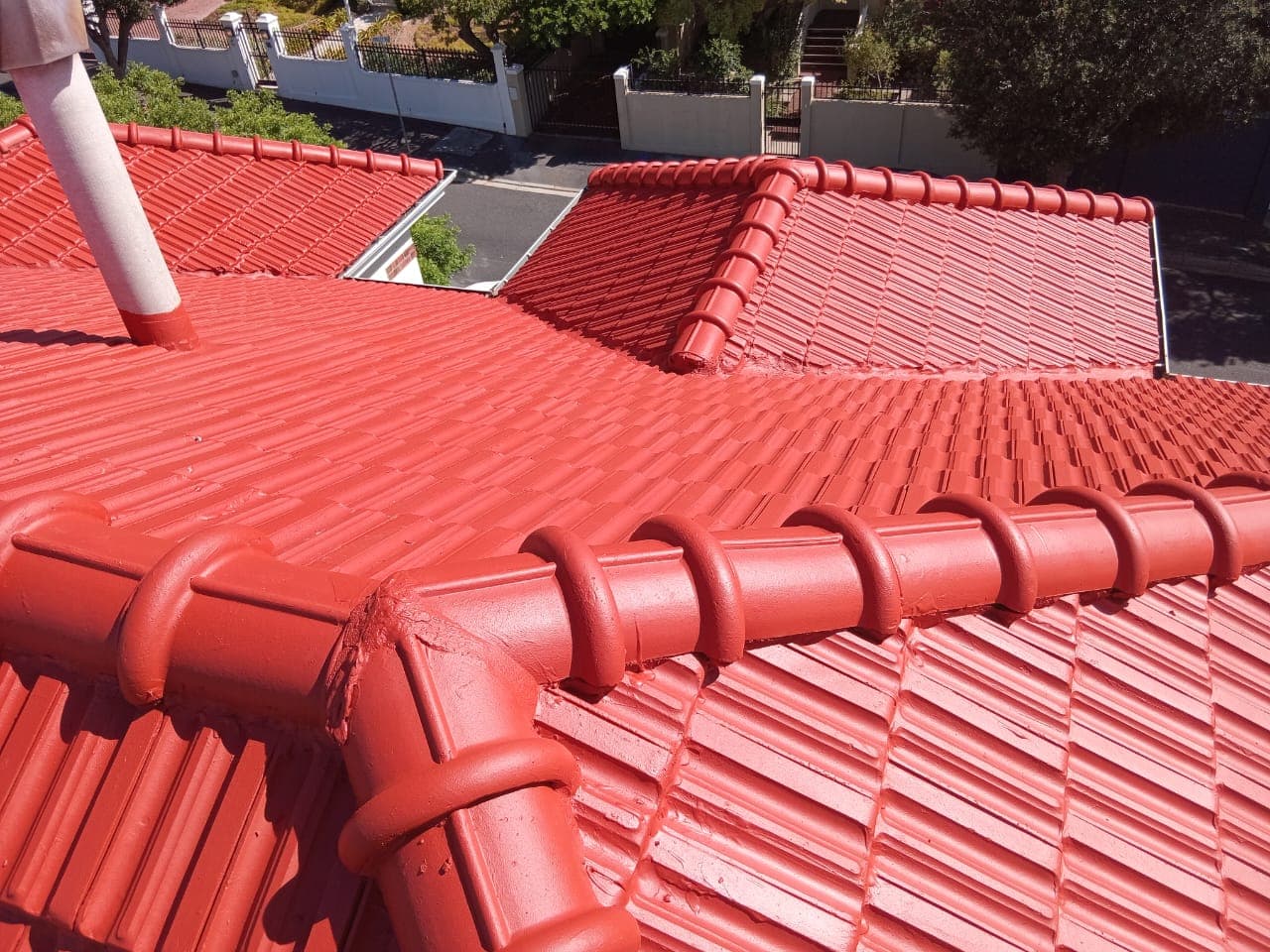 Red tiled roof showing multiple sections and guttering